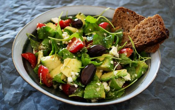 Delicious Greek salad featuring avocado, feta, and olives, ideal for a healthy meal.